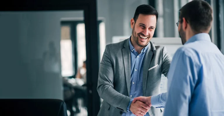 a man shaking hands with another man starting new job