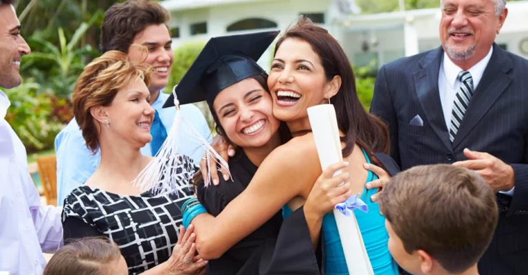 A new college graduate celebrating with their parents.
