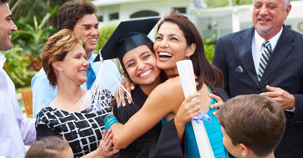 A new college graduate celebrating with their parents.