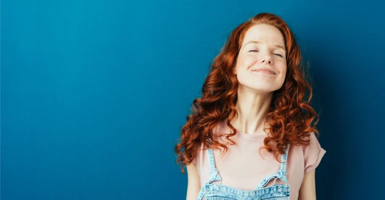 a woman with red hair and blue background career change