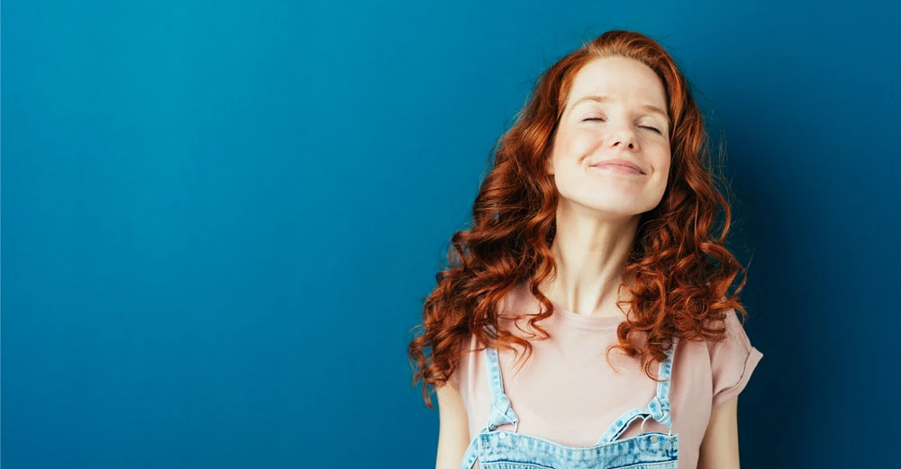 a woman with red hair and blue background career change