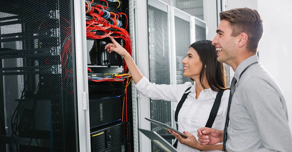a man and woman looking at a computer career focused education