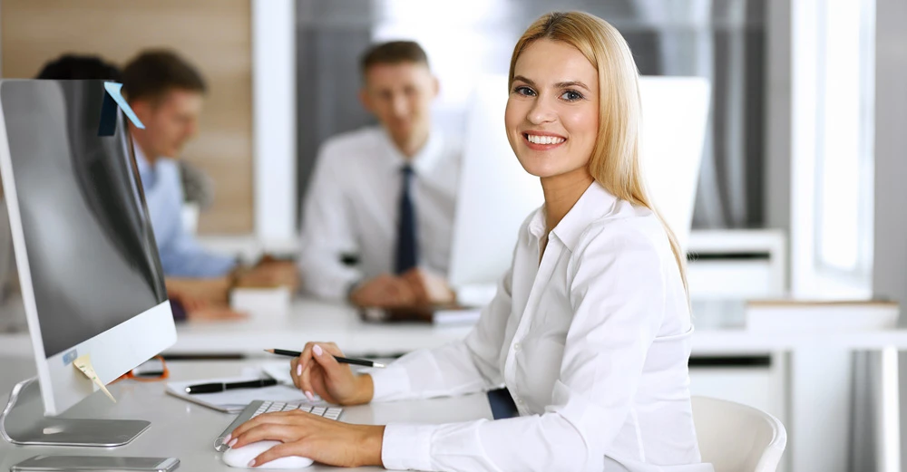 A business manager typing on a computer.