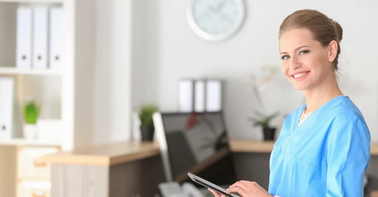 a woman holding a tablet unit clerk and medical office administrator