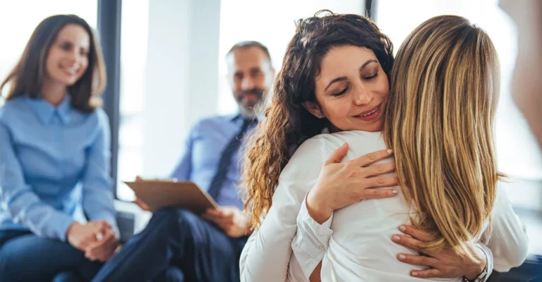 Two women embrace, indicative of actions that can make a difference during National Addictions Awareness Week.