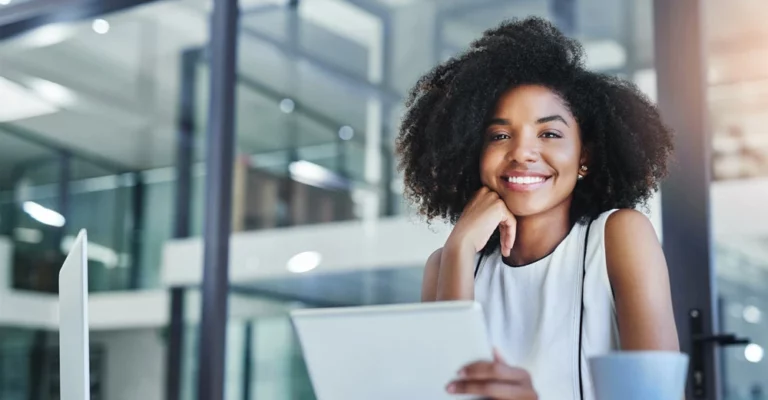 a woman smiling with her hand on her chin change career online college diploma