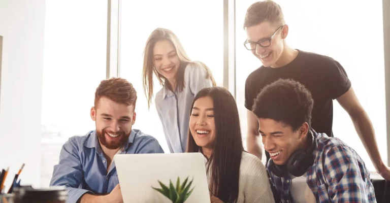 a group of people looking at a laptop online learning
