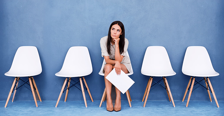 Woman waiting nervously before an interview, showing common job search mistakes like lack of preparation.