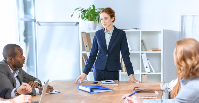 An HR professional collaborating with management in a boardroom, highlighting strategic HR planning.