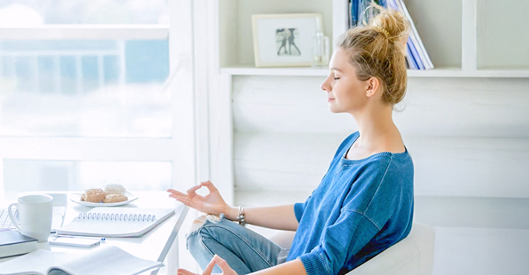 A young woman practicing self-care as part of healthy habits for the new year.