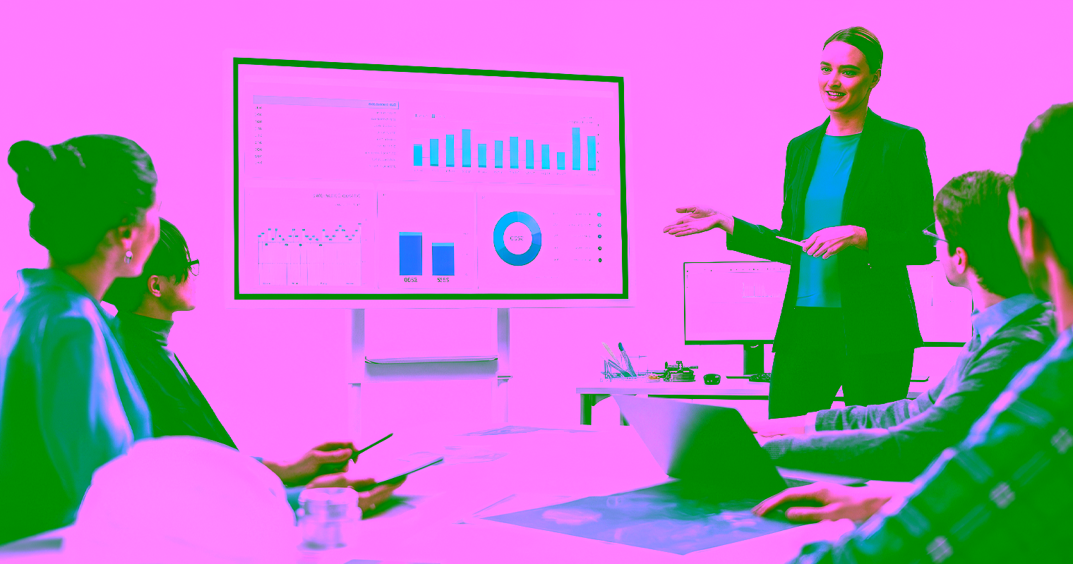 Businesswoman directing colleagues to look at screen with charts and graphs.